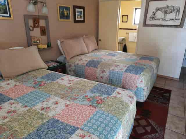 Mystic Santa Fe guest room: outdated decor and mismatched bedding for corporate event lodging.
