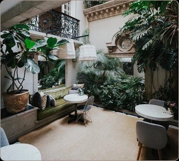 Biophilic courtyard breakout space for VIP consultations and networking events.