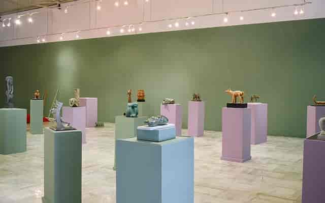 Modern art gallery interior with pedestal displays for cocktail mixers and networking events.