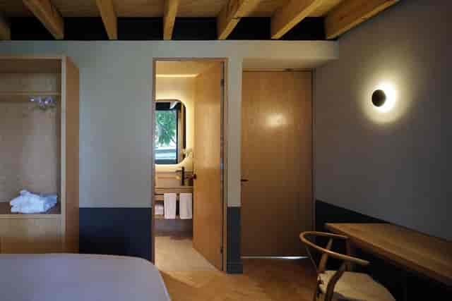 Minimalist executive suite at Maison Mexico Roma for corporate retreats and business travel.