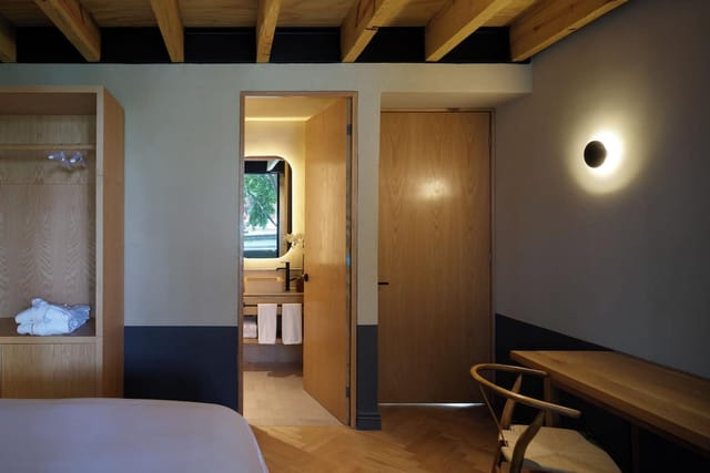 Minimalist executive suite at Maison Mexico Roma for corporate retreats and business travel.
