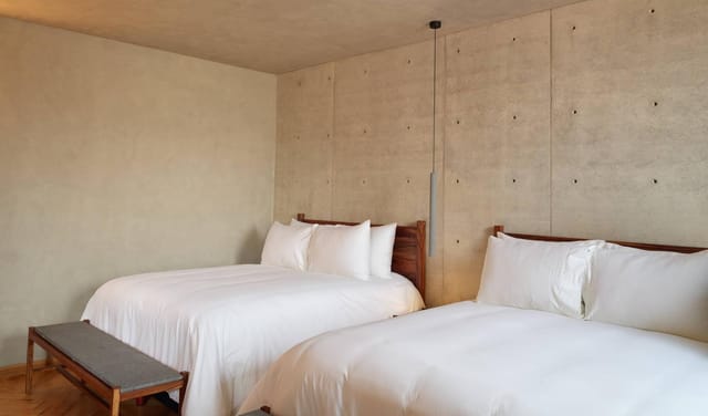 Modern hotel room with dual queen beds, ideal for corporate retreats and business events.