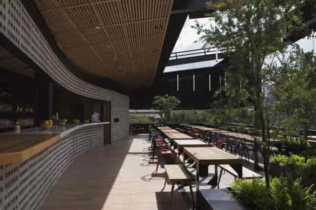 Rooftop venue at Maison Mexico Roma with communal tables for corporate networking events.