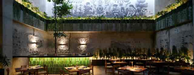 Biophilic restaurant venue in Maison Mexico Roma, featuring industrial mural for corporate events.