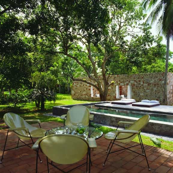 Outdoor poolside restaurant seating at Maison Couturier for corporate retreats and networking.