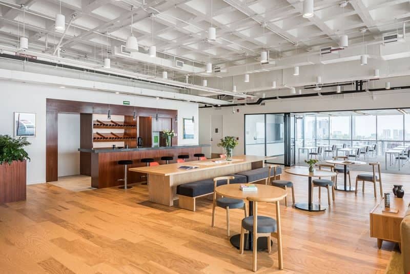 Modern office lounge with bar seating for corporate networking and business event space rental.