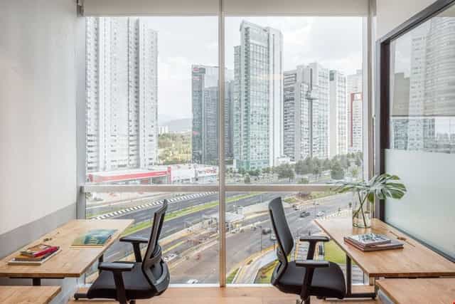 Minimalist office breakout room with urban views for VIP strategy meetings and corporate rental.