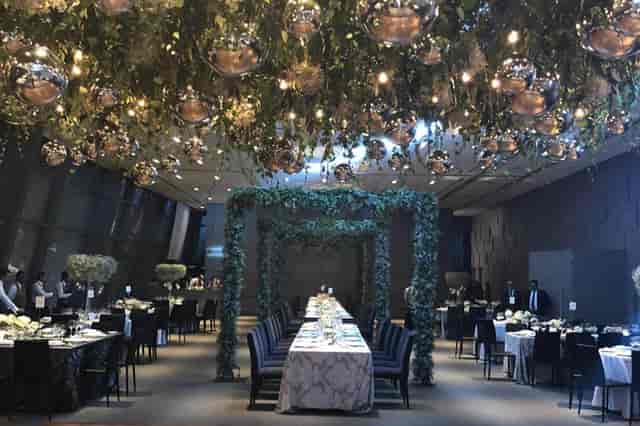 Salón Candiles event venue with hanging globe lights and greenery for weddings and gala dinners.