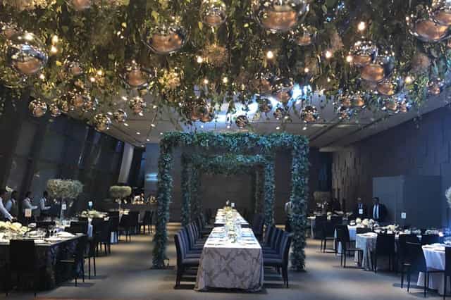 Salón Candiles event venue with hanging globe lights and greenery for weddings and gala dinners.