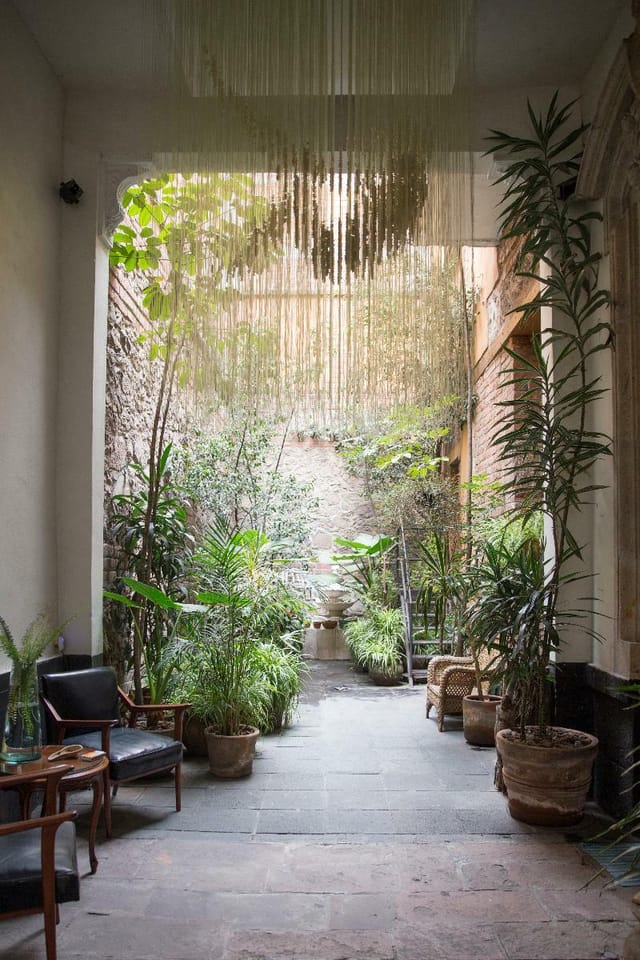 El Patio 77 biophilic hotel breakout space for high-end corporate networking and meetings.