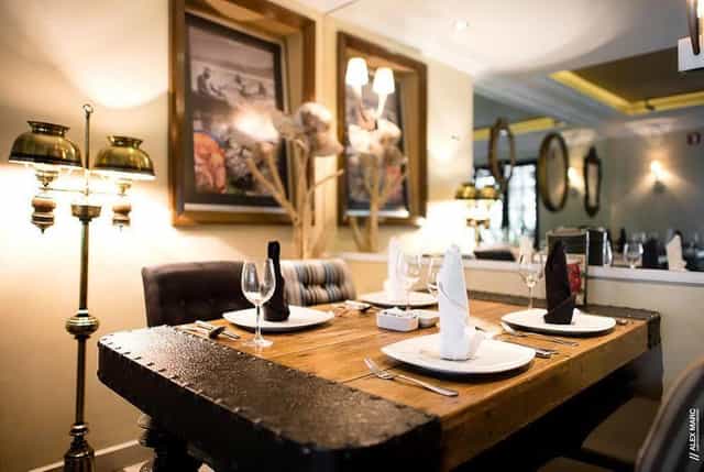 Rustic-industrial hotel restaurant for high-end VIP business dinners and breakout sessions.