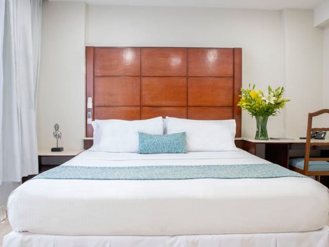 Hotel in Suites Coben standard room with workspace for business travel and guest accommodation.