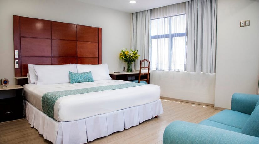 Hotel in Suites Coben guest room with workspace for event accommodation and group blocks.