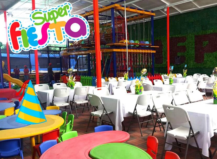 Kids' event venue with modular seating and active play structure for birthday parties and functions.