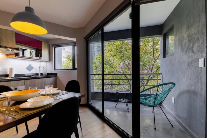 Modern 1BR apartment in Capitalia Condesa with balcony; luxury urban real estate rental.