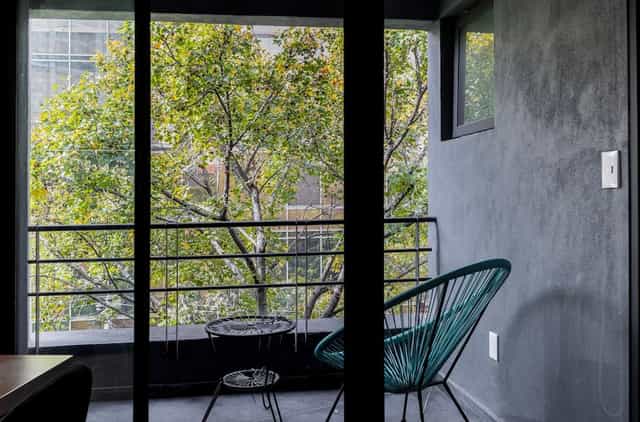 Chic 1BR condo balcony for networking or conference breakout space in Capitalia Condesa Escandon.