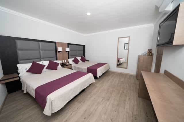 Double queen suite at Hotel Mónaco Mexico City for event lodging and business group travel.
