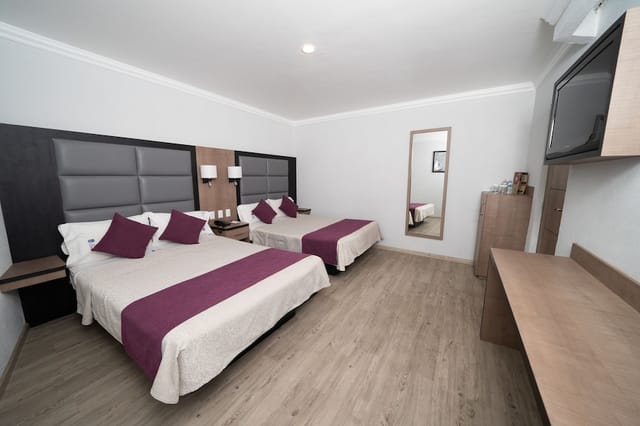Double queen suite at Hotel Mónaco Mexico City for event lodging and business group travel.
