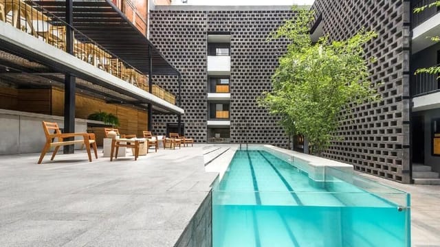 Hotel Carlota pool bar courtyard for VIP cocktail receptions and boutique networking mixers.