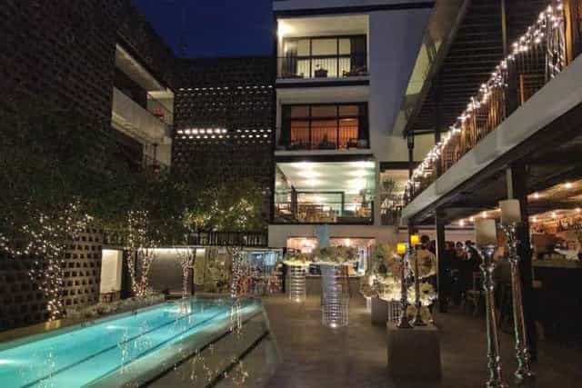 Alberca Bar at Hotel Carlota: intimate poolside boutique wedding reception venue with fairy lights.