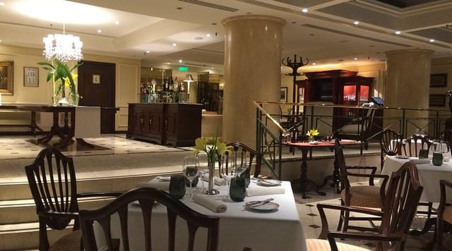 Upscale St. Regis private dining room with elegant table settings for board dinners and receptions.