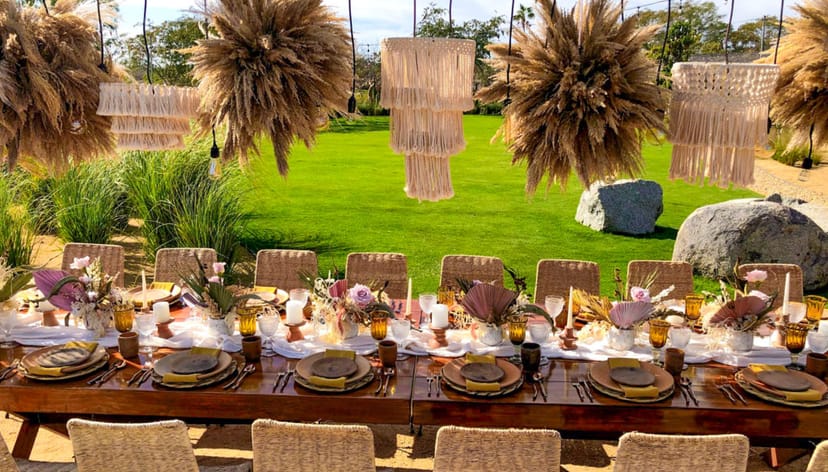 Boho-chic outdoor banquet setup at El Huerto restaurant with pampas grass for wedding event venue.
