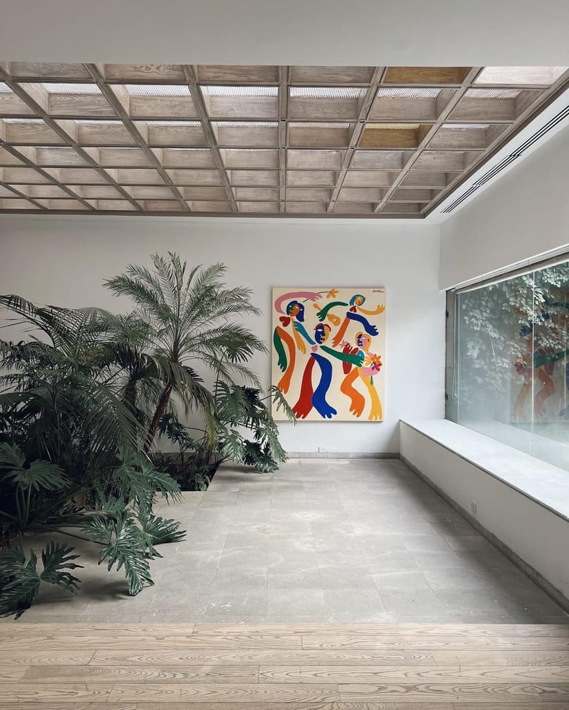Art studio breakout space with greenery for high-end networking and VIP reception events.
