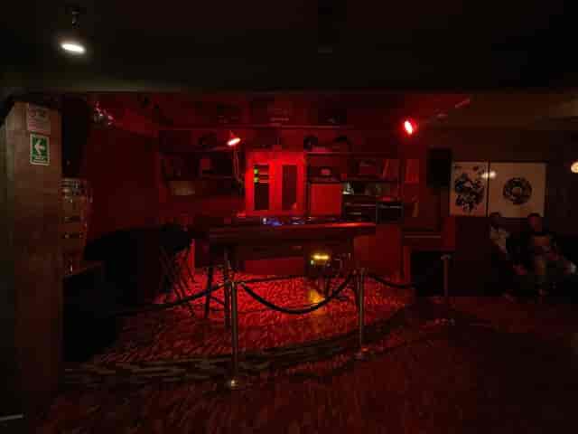 Departamento Studio Bar VIP lounge with red mood lighting for exclusive event stage.