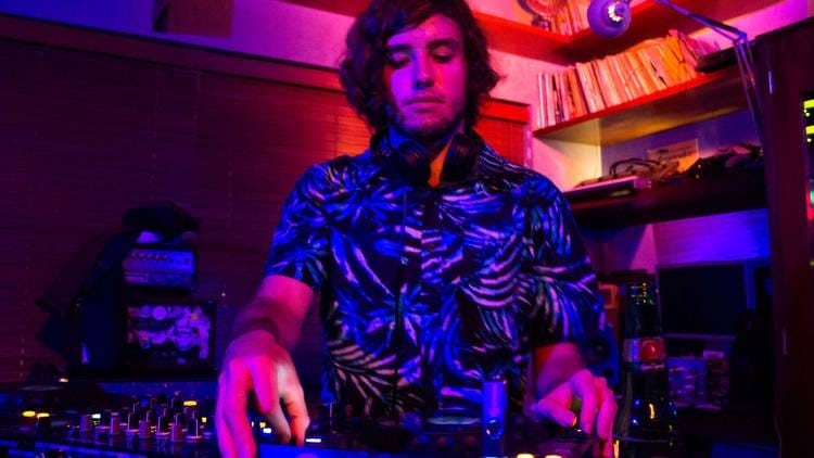 DJ at Departamento Studio Bar with atmospheric lighting for corporate events and private parties.
