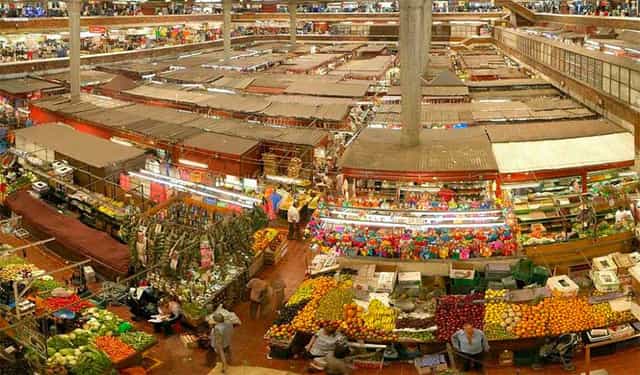 Mercado San Joaquin indoor market: crowded vendor stalls, ideal for street food festivals or pop-ups.