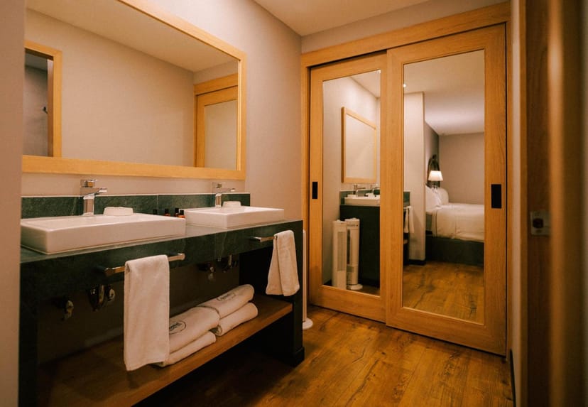 Modern hotel bathroom with dual vanity, ideal for VIP conference and corporate event accommodation.