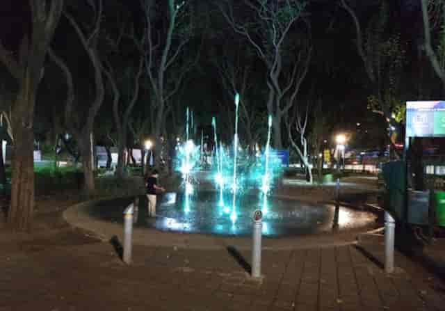 Illuminated fountain at Parque María Enriqueta Camarillo for evening event venue activation.