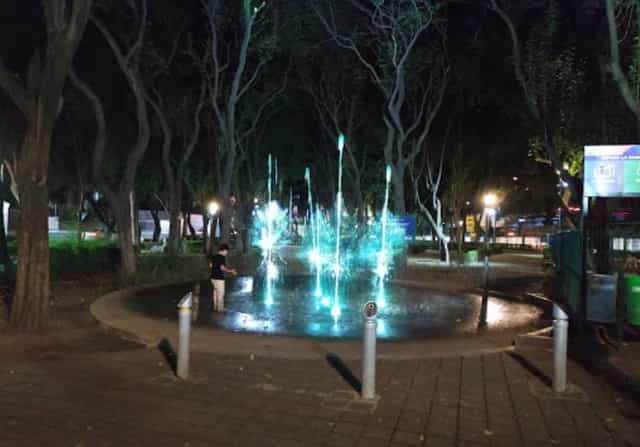 Illuminated fountain at Parque María Enriqueta Camarillo for evening event venue activation.