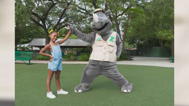 Mascot engaging with children at The Great Lawn in San Antonio Zoo for family events.