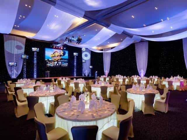 Avalon Ballroom with ceiling draping and stage trussing for corporate events and gala dinners.