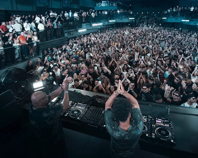 Sold-out live performance at UNVRS main floor with high-energy crowd, club event, concert venue.
