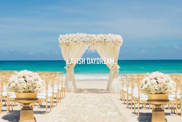Beachfront wedding at Fania Ballroom, Hard Rock Riviera Maya with elegant floral arch and gold decor.