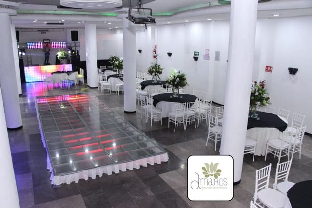 Banquet hall at Salones Amarilis with illuminated dance floor for wedding and corporate events.