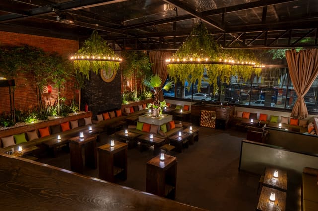 Industrial event venue at Club del Patio Roma with lush greenery for evening receptions or mixers.