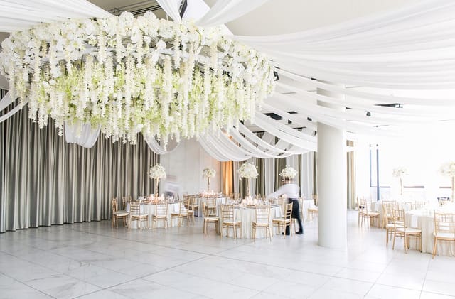 Elegant event space with floral ceiling for formal reception and luxury wedding venue hire.