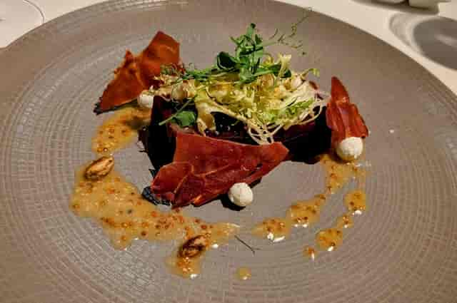 Gourmet banquet starter on textured plate for luxury incentive trips and upscale gala dinners.