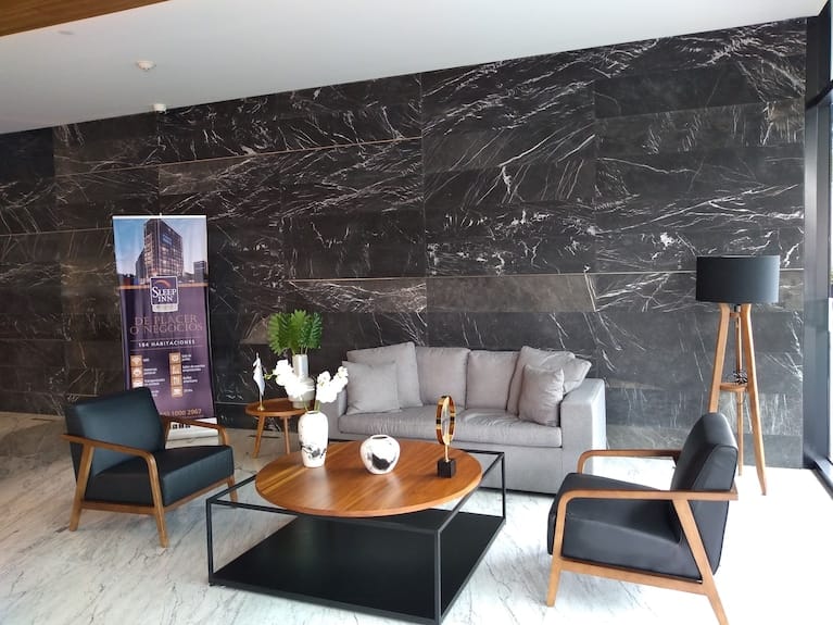 Upscale Sleep Inn meeting room with marble wall for business networking and VIP events.
