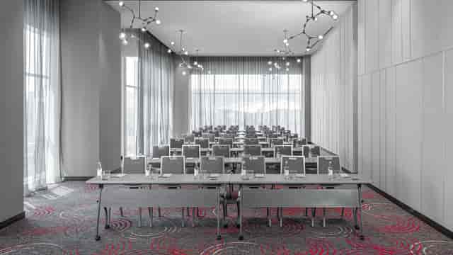 Modern conference room with classroom seating for corporate workshops and training sessions.