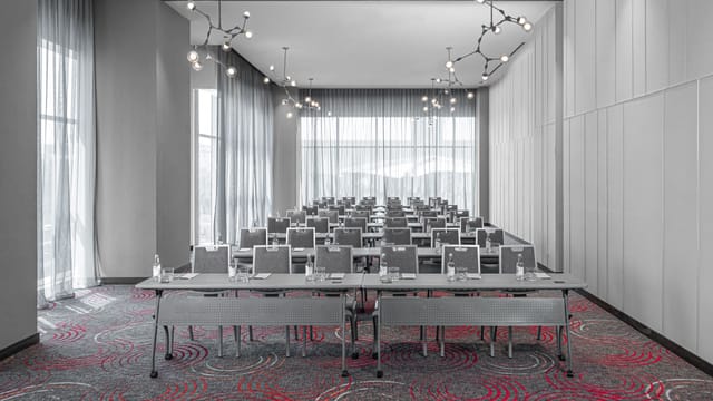 Modern conference room with classroom seating for corporate workshops and training sessions.