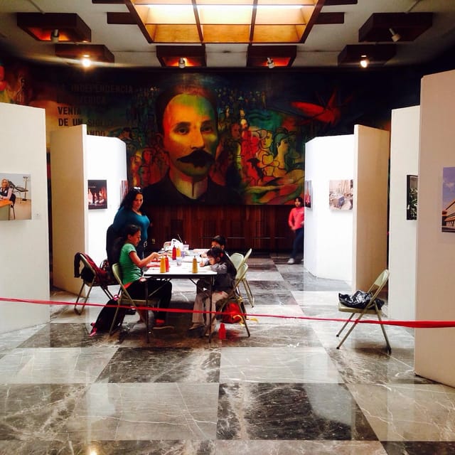 Workshop at José Martí Cultural Center with mural backdrop for creative events and gallery meetings.