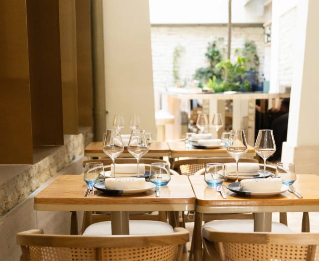 Aquiles Restaurant: Intimate dining space with natural light for VIP luncheons and private events.