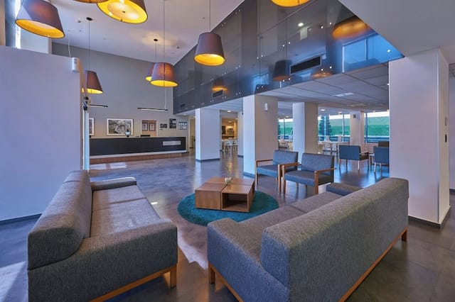 Modern hotel breakout room for business meetings and professional networking events.