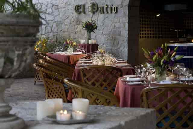 Upscale outdoor dining at El Cid Granada Hotel: elegant candlelight setting for private events.