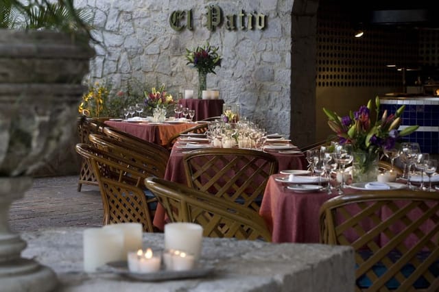 Upscale outdoor dining at El Cid Granada Hotel: elegant candlelight setting for private events.
