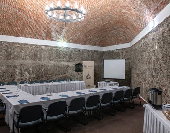 U-shape boardroom at Hacienda Cocoyoc with stone walls for corporate meetings and event venues.